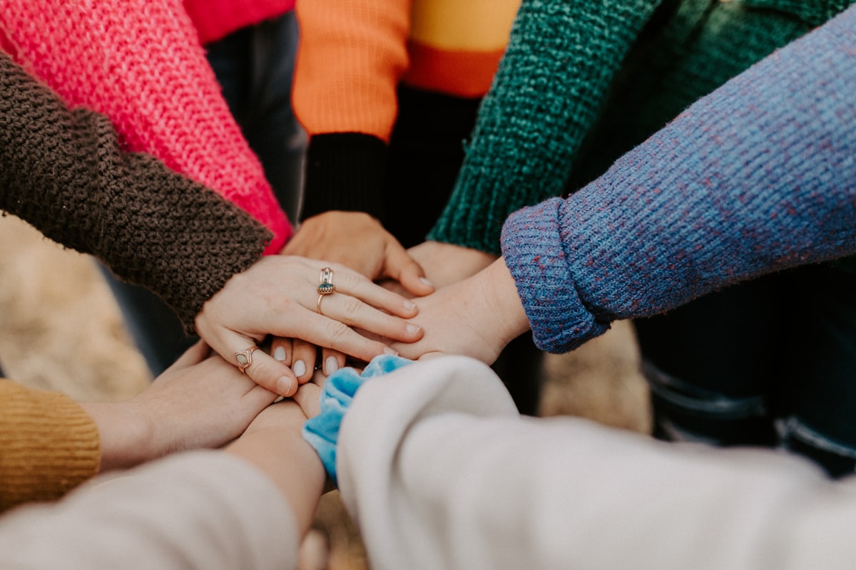 People joining hands in community